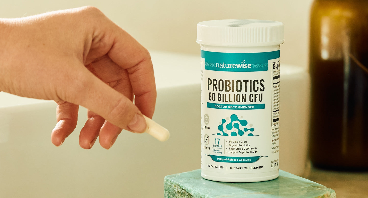 hand taking probiotics