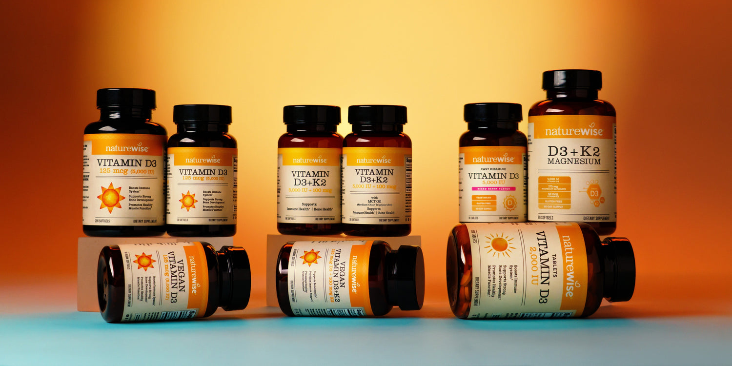 Vitamin D3 vs. Vitamin D3 + K2. NatureWise Vitamin D3 Supplement Bottles on a golden background