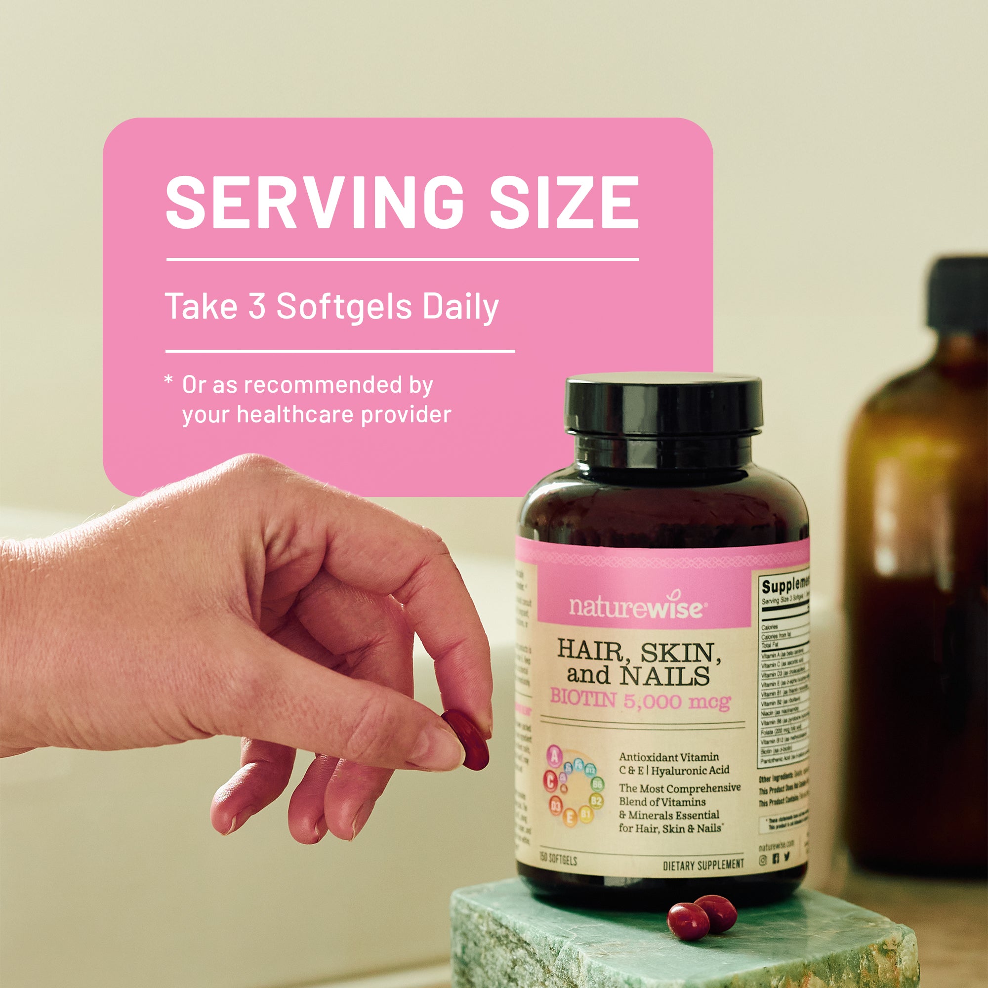 Naturewise hair, skin, and nails supplement bottle with a hand holding a softgel and pink label with serving size information.