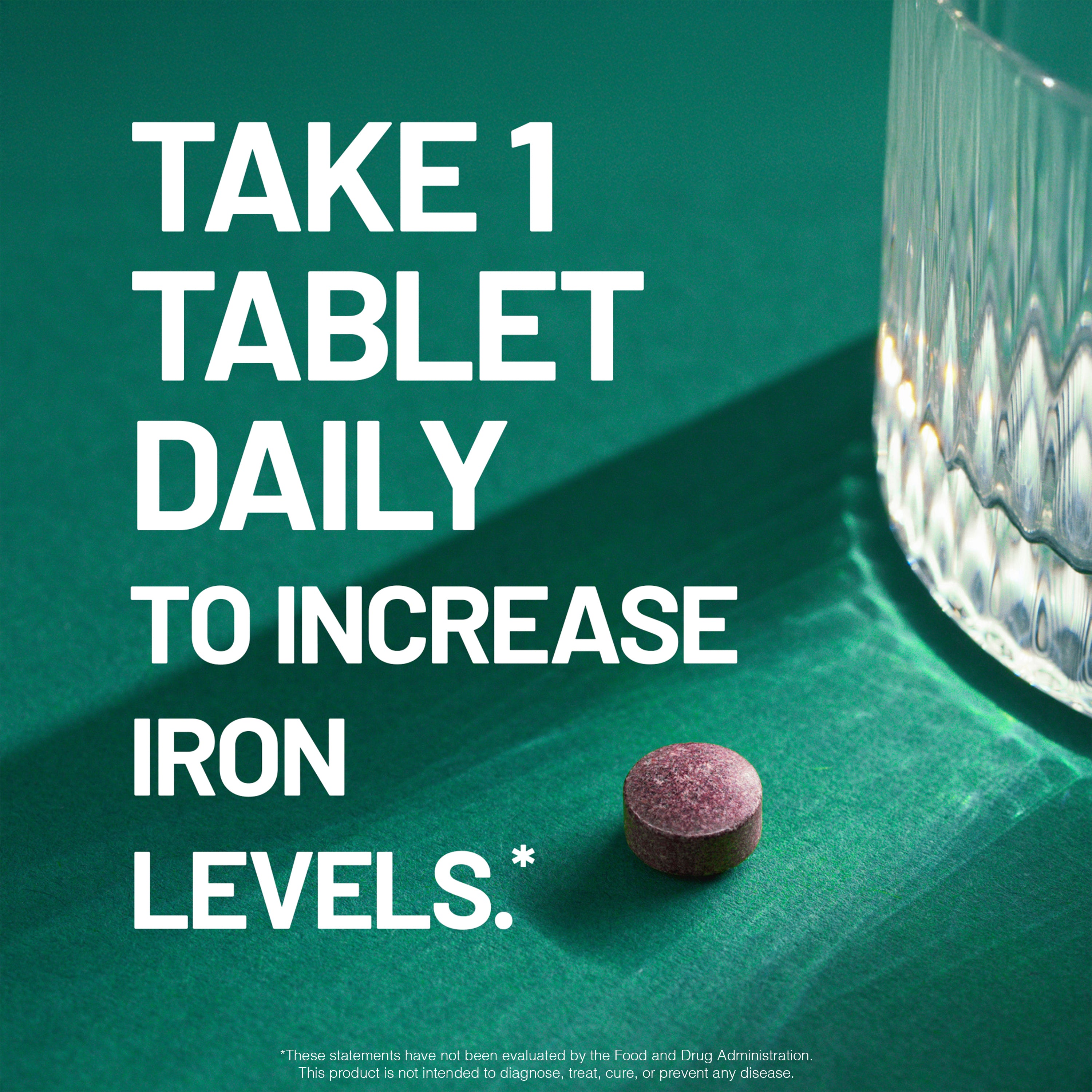 Purple iron supplement tablet on a green surface with text about daily intake.