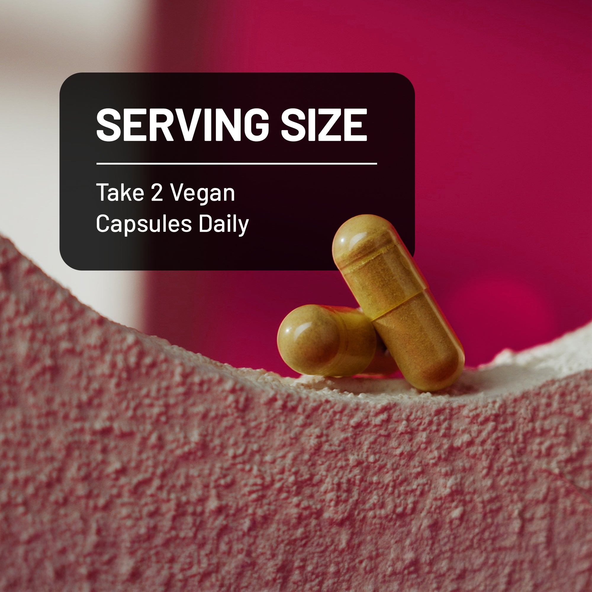 Two vegan capsules on a textured surface with text about serving size and daily consumption.