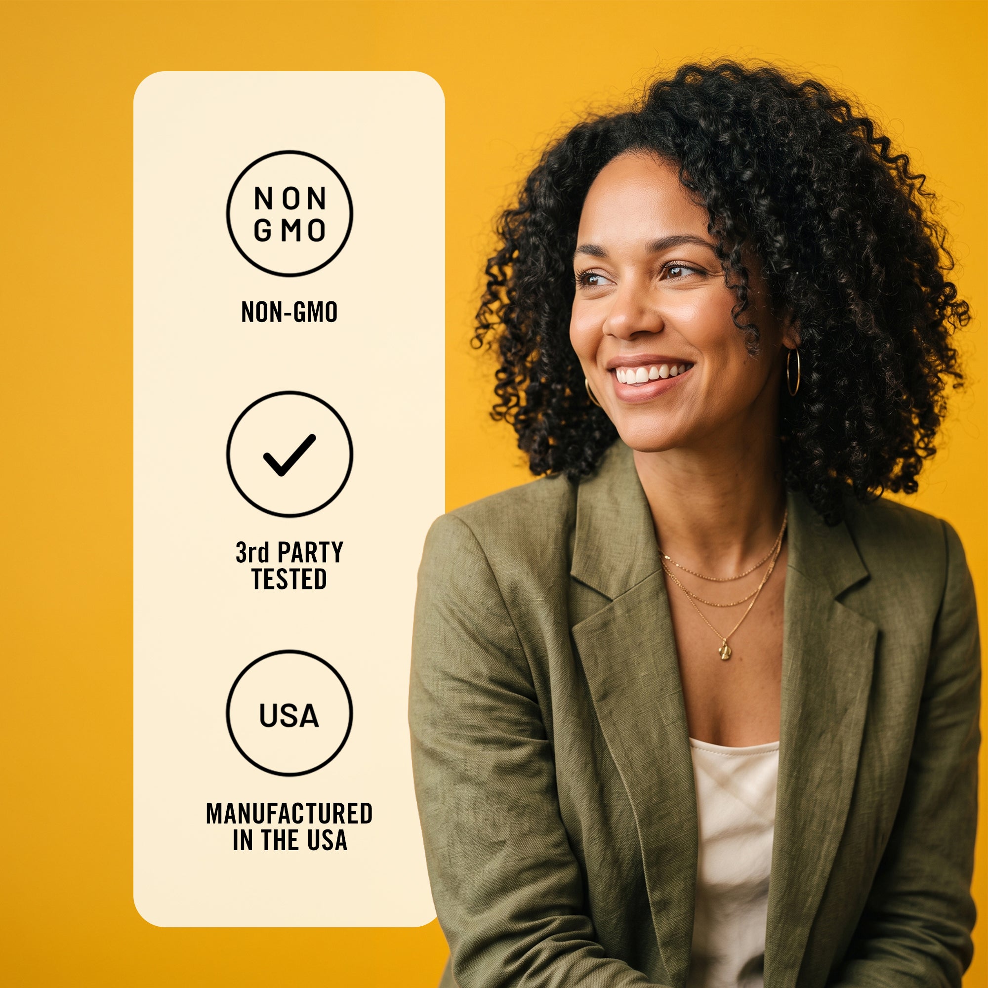 A smiling woman with curly dark hair wears an olive green blazer over a white top against a solid yellow background. To her left is a vertical cream card with black text and icons reading 'NON GMO', '3rd PARTY TESTED', and 'MANUFACTURED IN THE USA'.