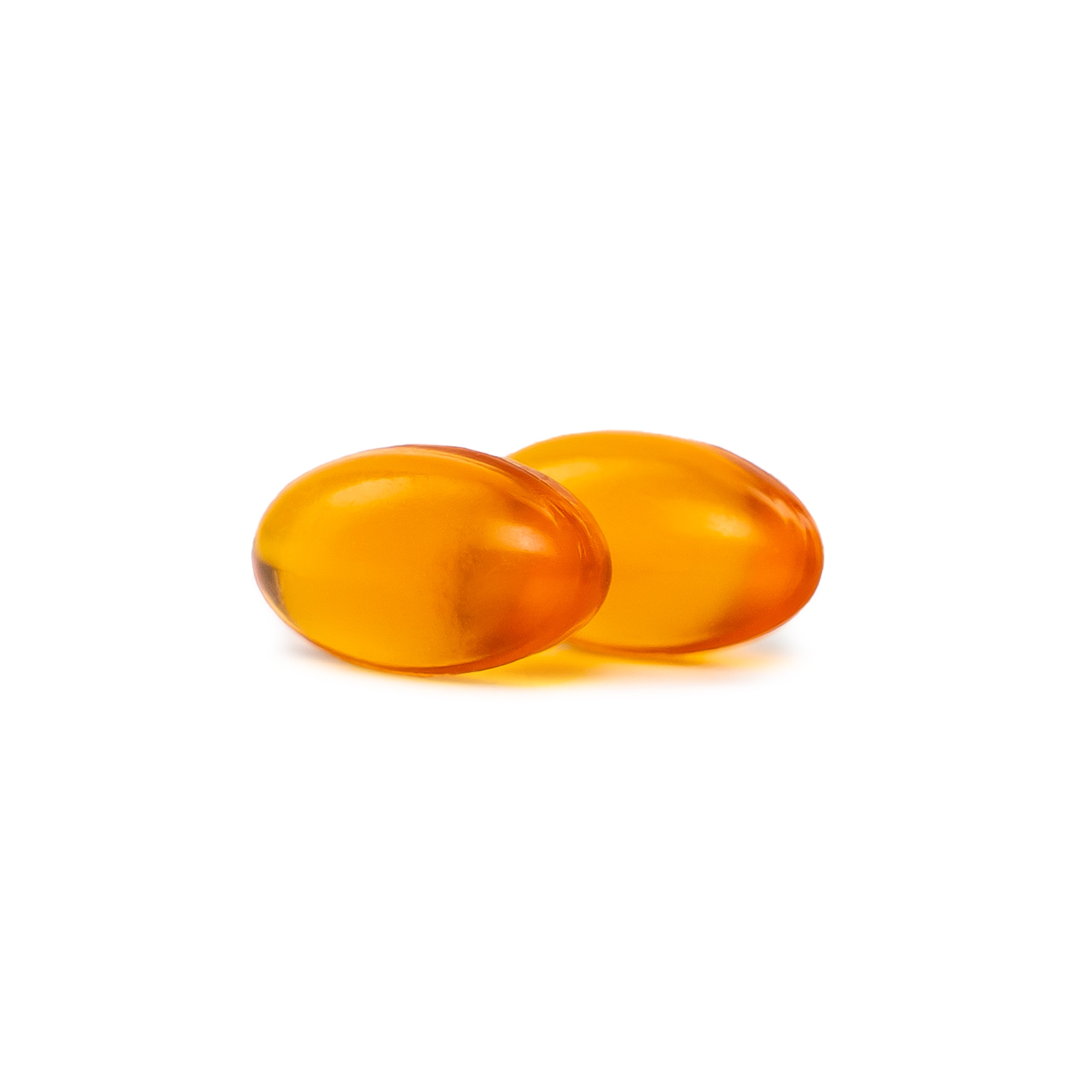 Two Orange Vegan Oil of Oregano softgels on a white background