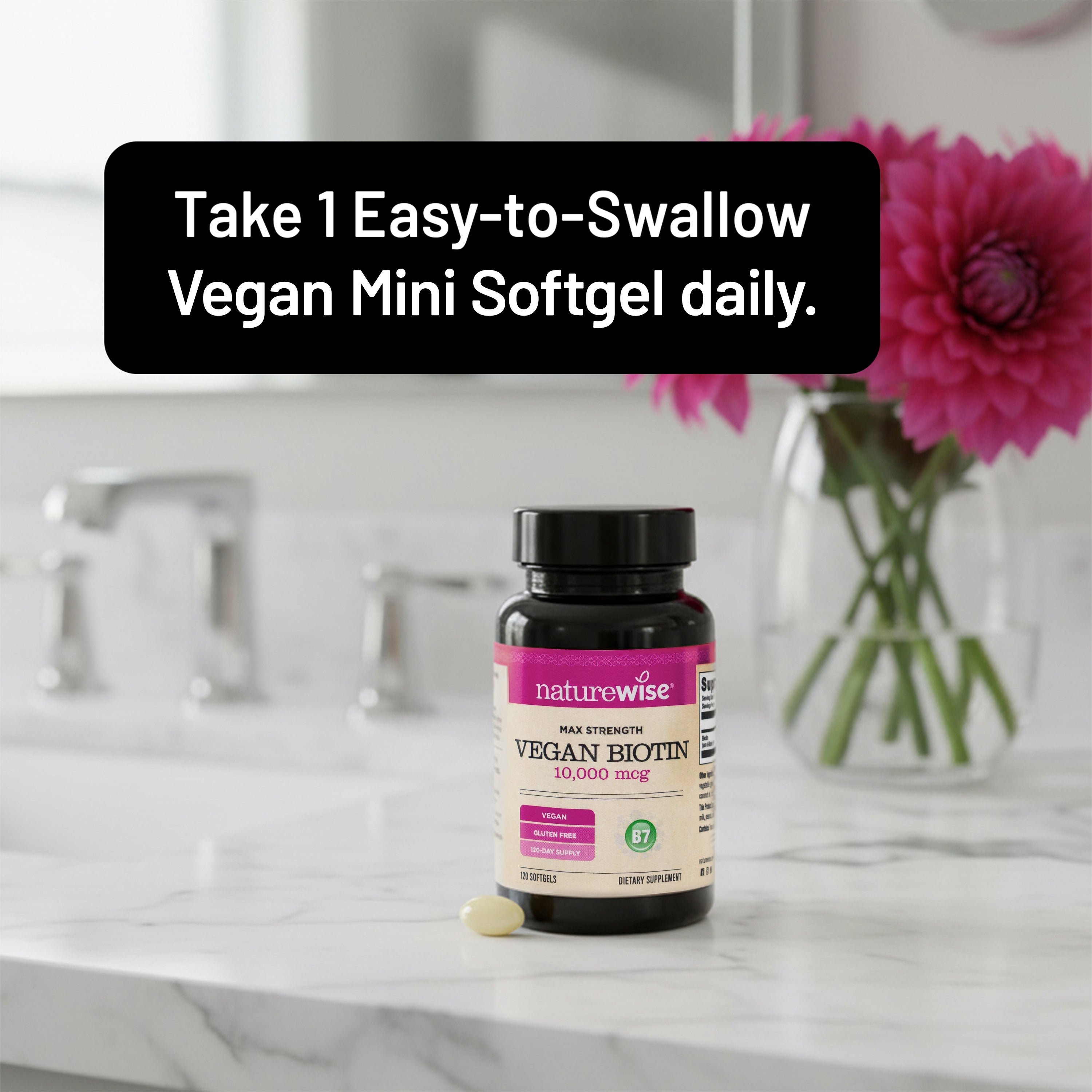 NatureWise Vegan Biotin 10,000 mcg supplement bottle on a marble surface with text about suggested serving size.