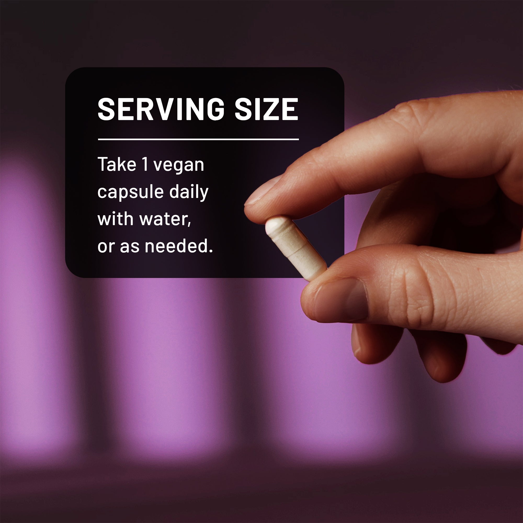 Hand holding a small NatureWise Zinc Picolinate capsule with serving size instructions on a dark background
