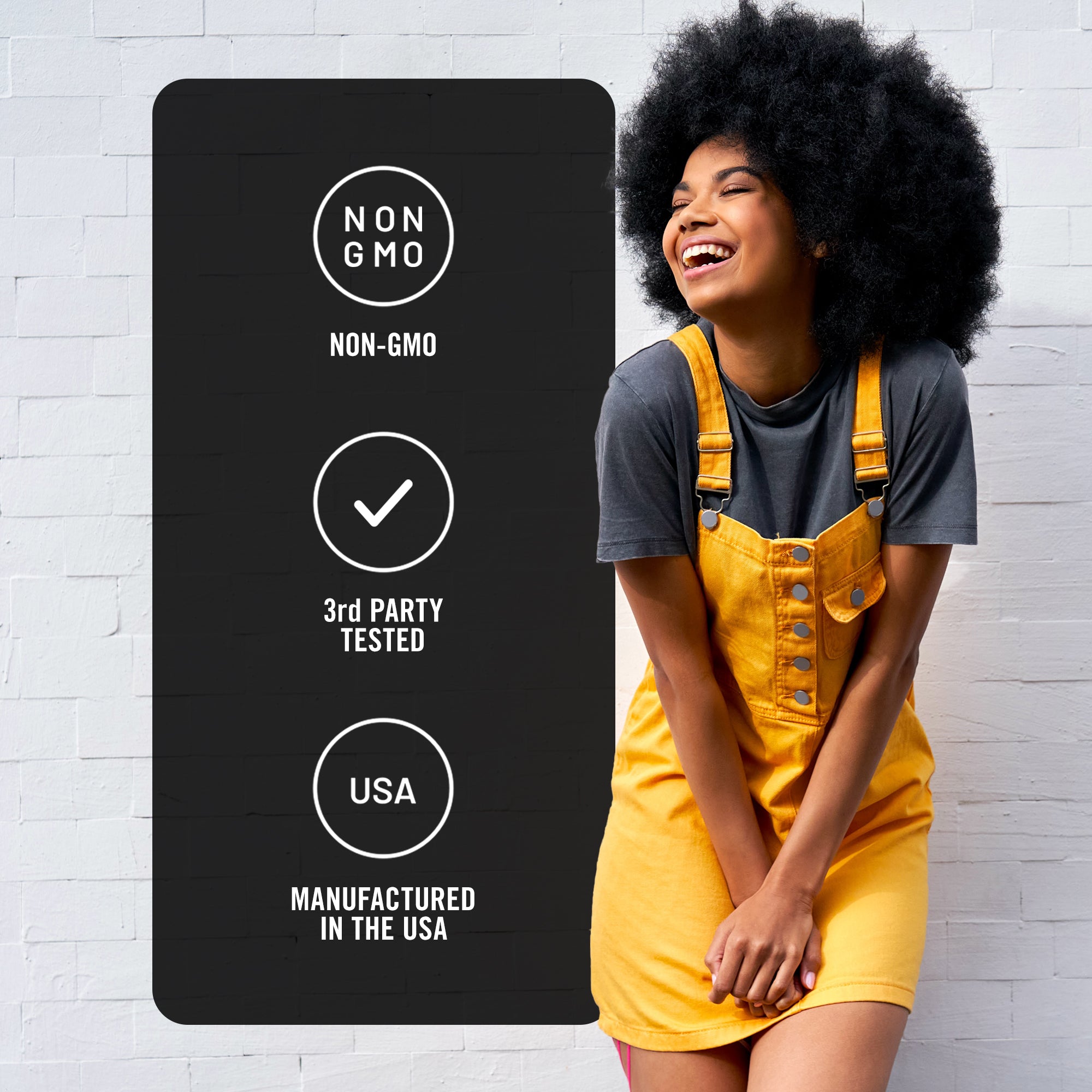 Woman in yellow overalls standing next to a black label with Non-GMO, 3rd Party Tested, and Manufactured in the USA certification icons