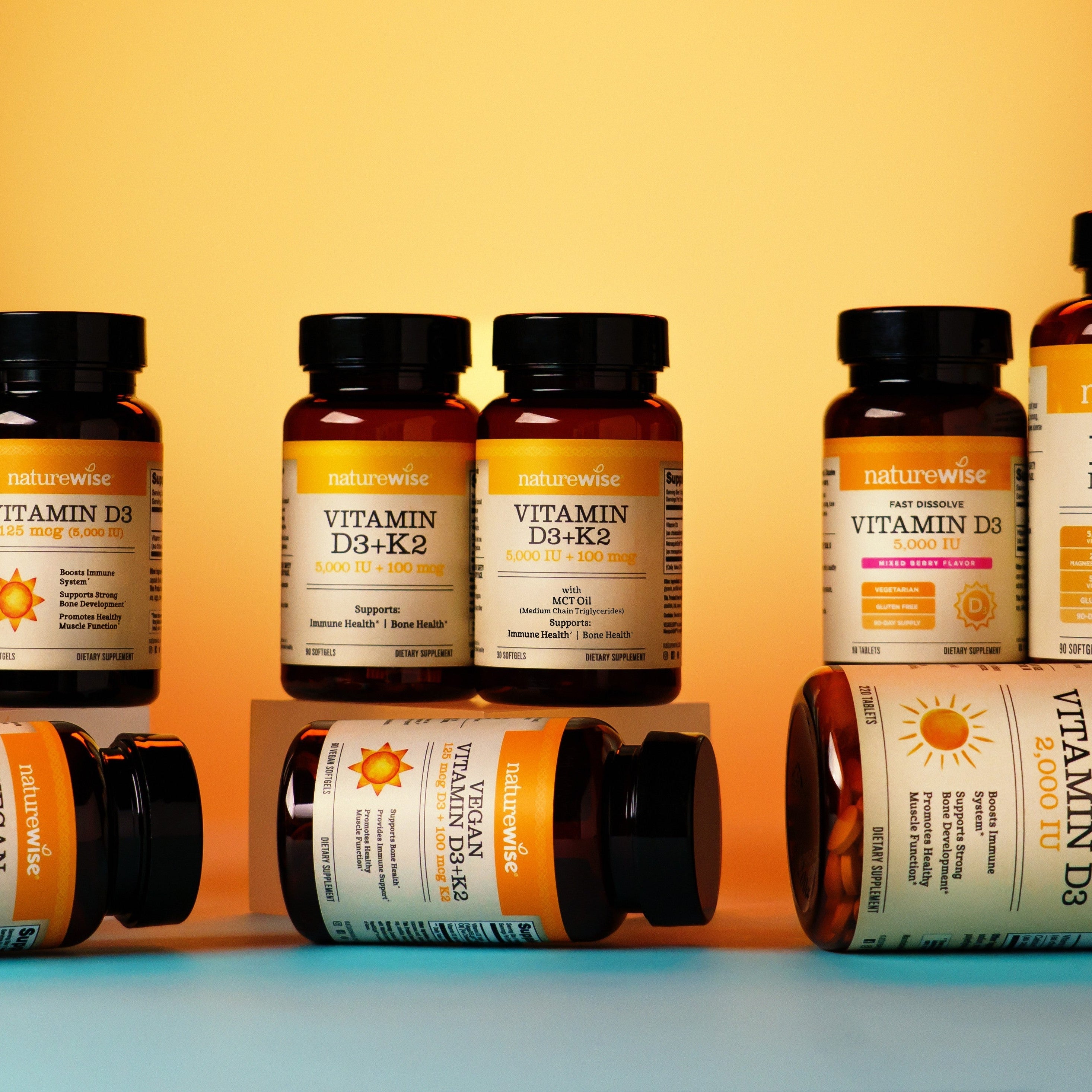 Vitamin D3 vs. Vitamin D3 + K2. NatureWise Vitamin D3 Supplement Bottles on a golden background