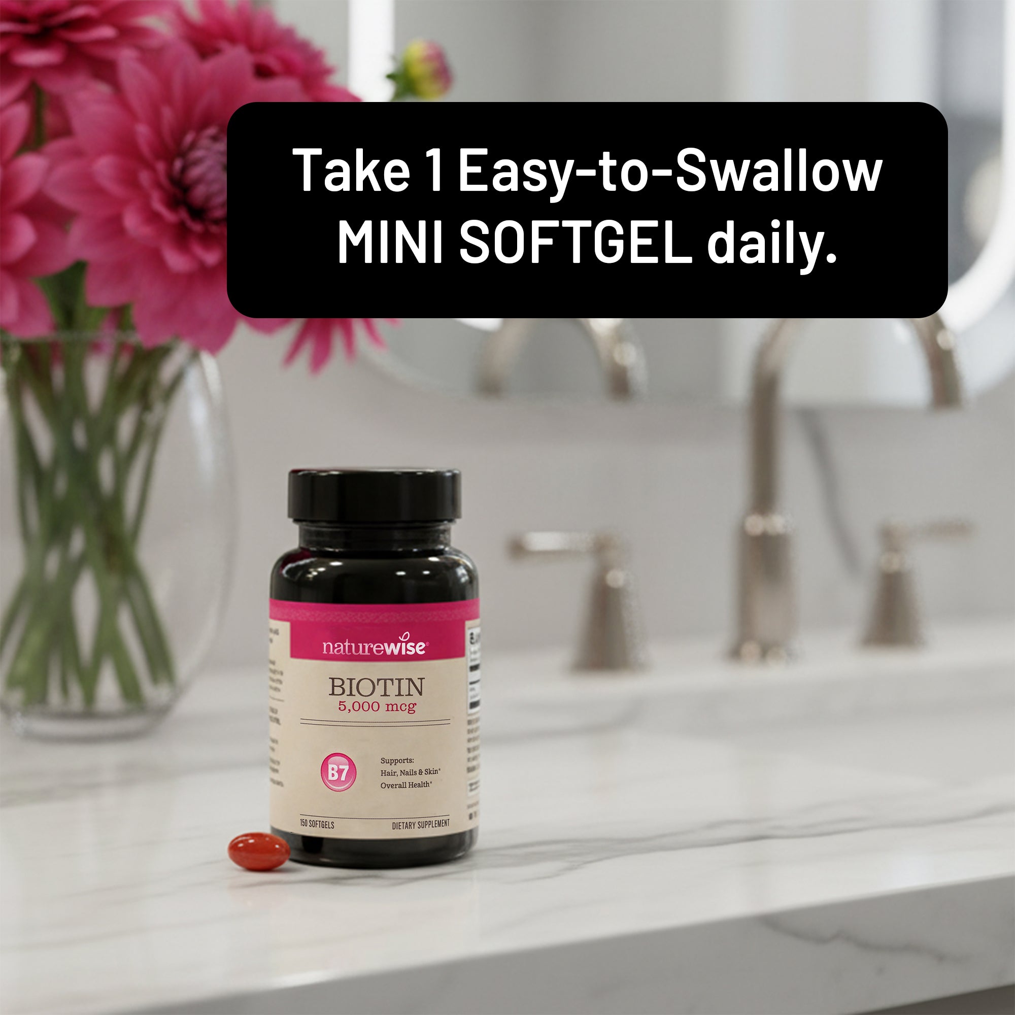 NatureWise Biotin supplement bottle on a bathroom counter with flowers in the background