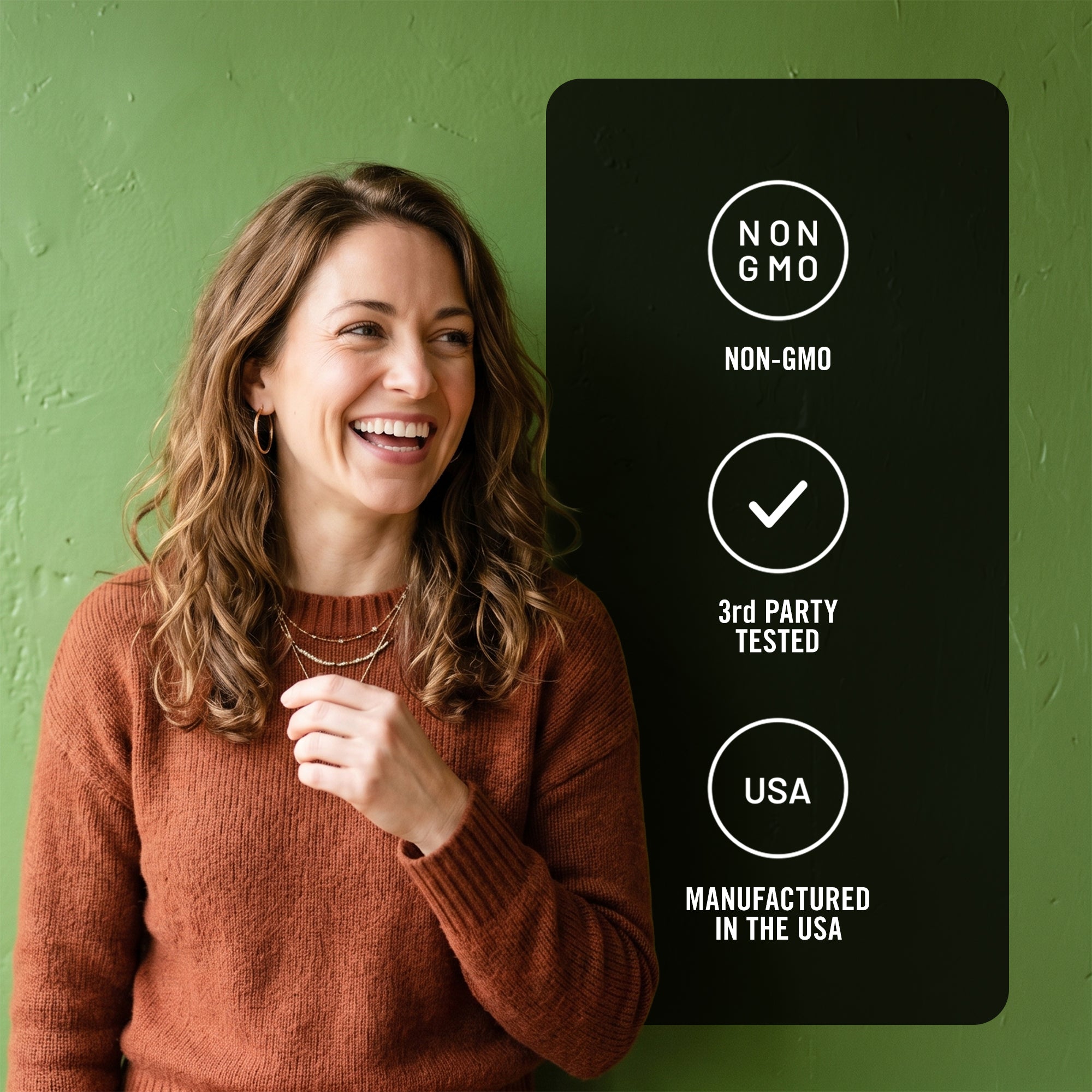 Woman standing next to a black sign with certification labels on a green background