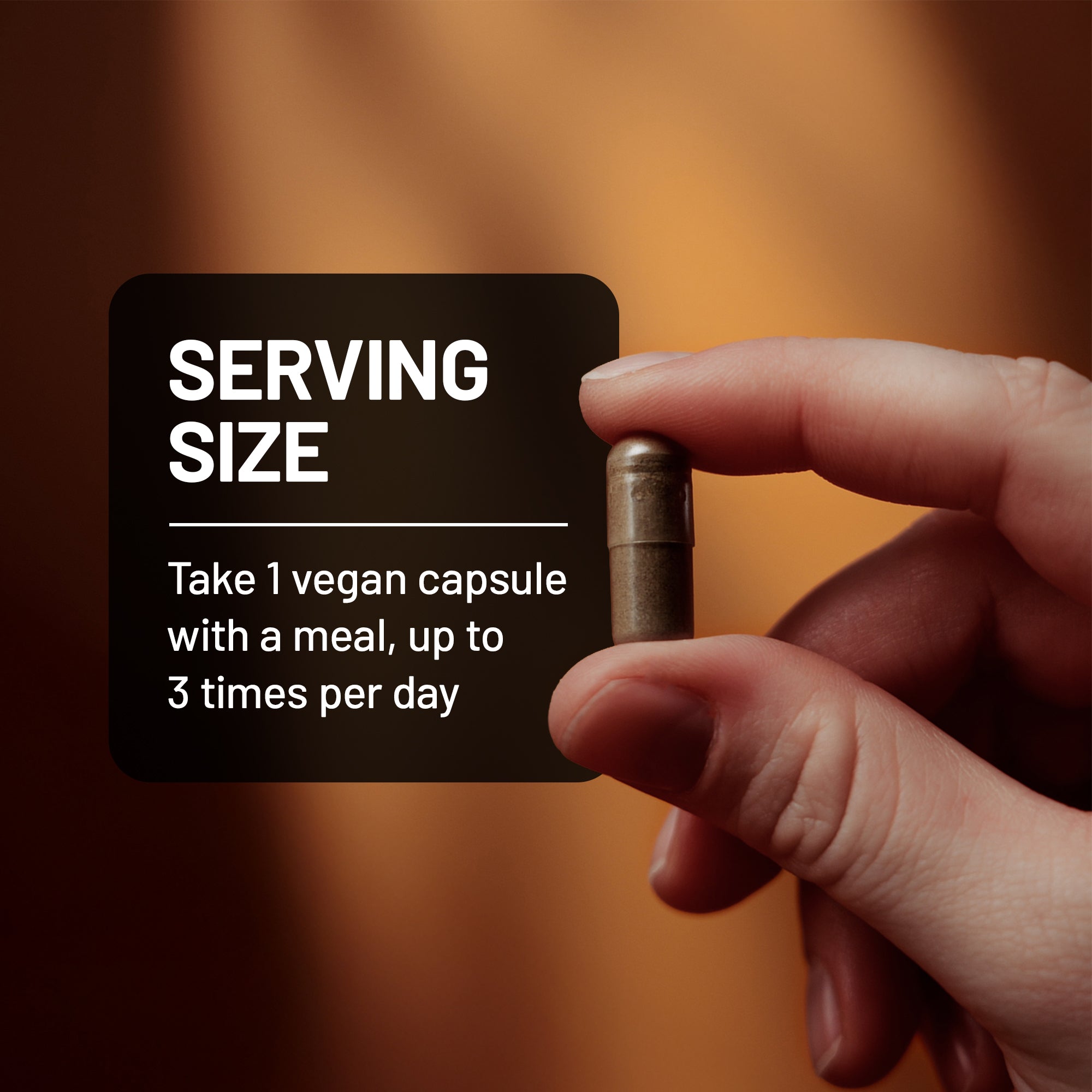 Hand holding capsule showing the serving size of the natural laxative supplement.