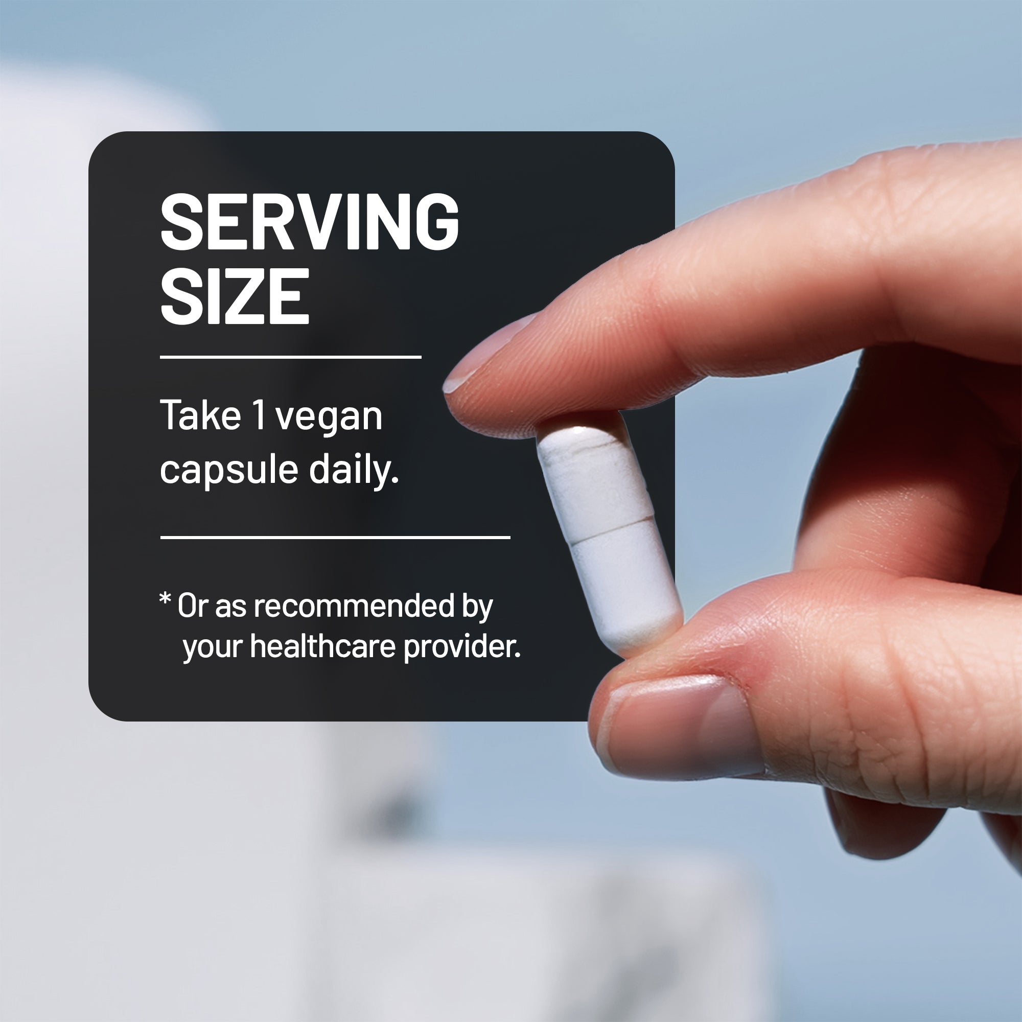 Hand holding a NatureWise Magnesium Glycinate supplement capsule with a label about serving size and vegan capsules.