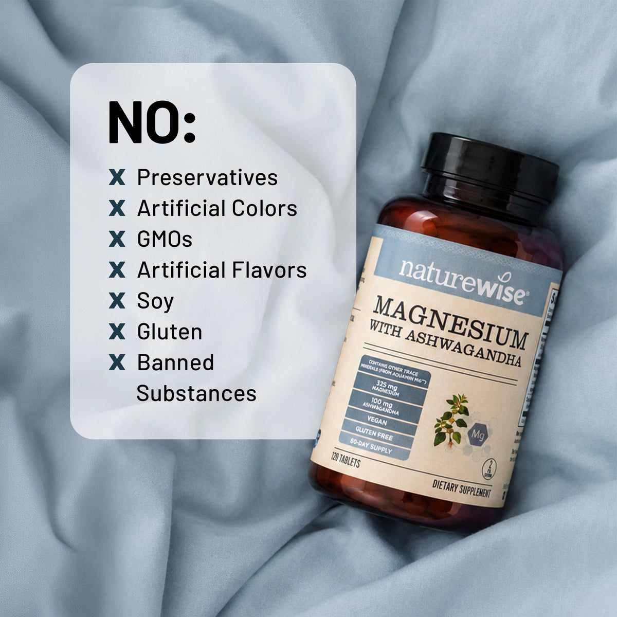 A bottle of NatureWise Magnesium with Ashwagandha dietary supplement lies on draped light blue fabric next to a white informational card listing excluded ingredients like preservatives, artificial colors, GMOs, and soy.