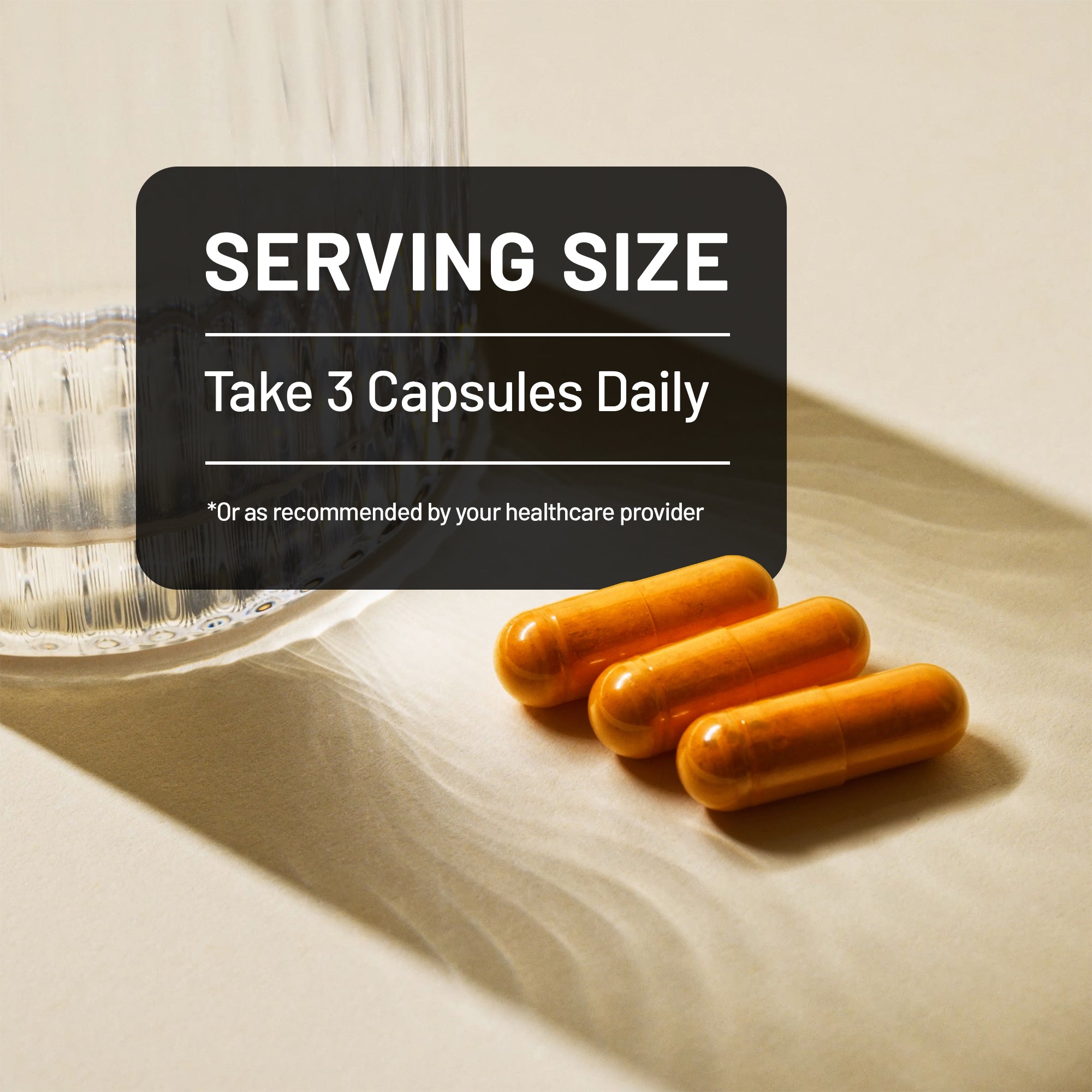 Three orange capsules on a beige surface with a label indicating 'Take 3 Capsules Daily' on a black background.