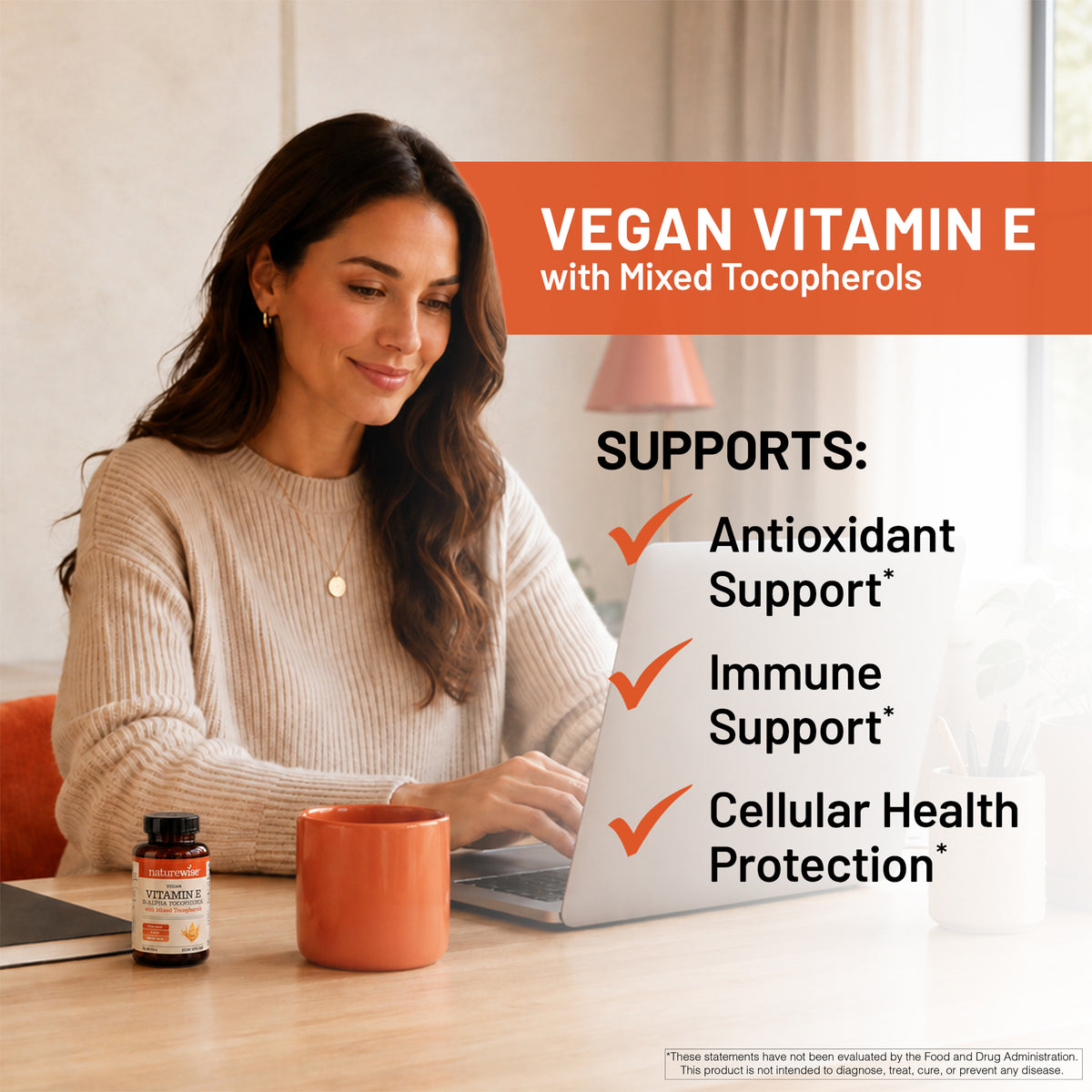 A woman sits at a wooden desk using a laptop next to a small bottle of vegan vitamin E with mixed tocopherols and an orange mug. The image features a promotional text overlay on the right detailing the benefits of vitamin E.