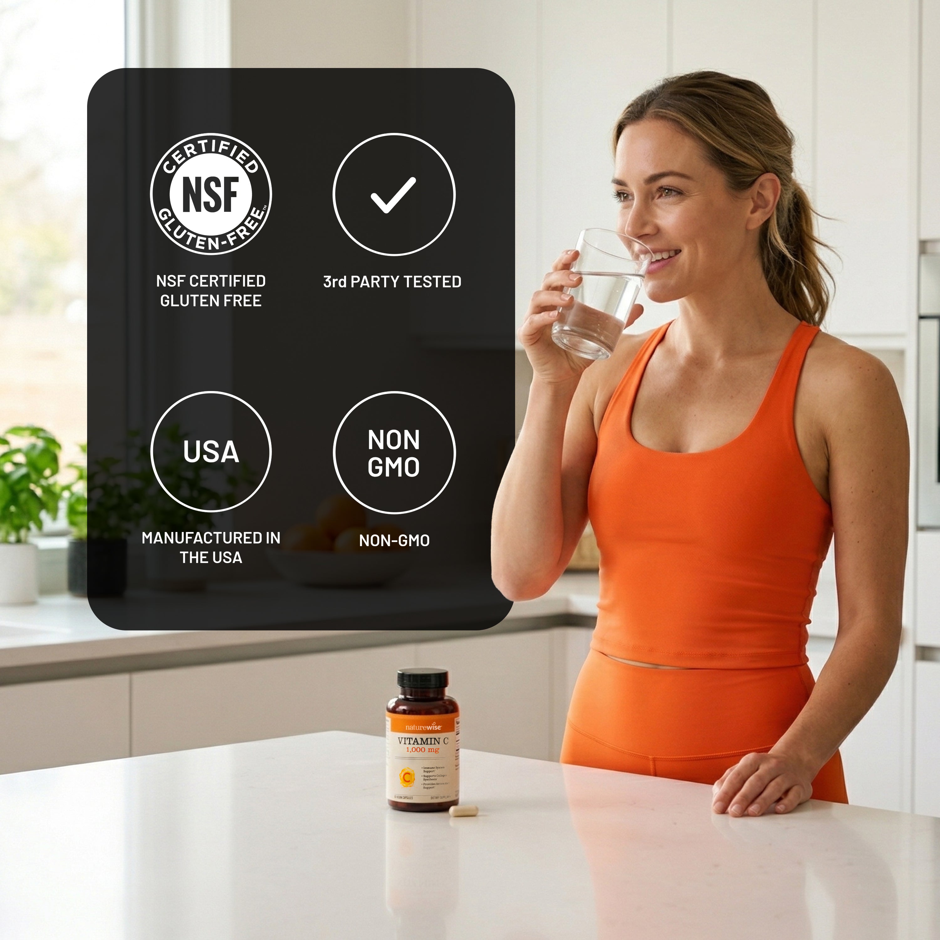 Woman in an orange tank top holding a glass of water next to a NatureWise Vitamin C supplement bottle with certification labels on a kitchen counter.