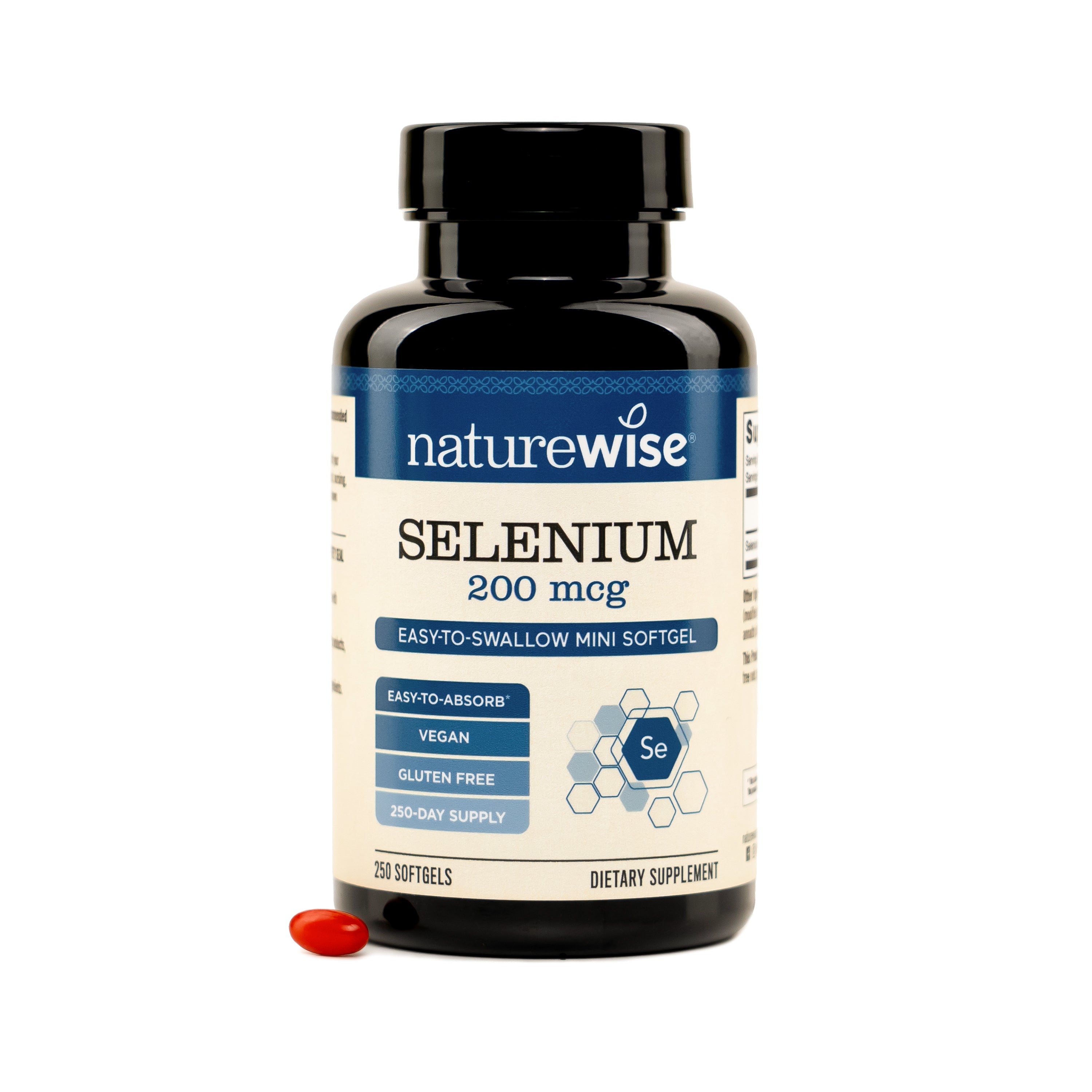 A bottle of NatureWise Selenium 200 mg dietary supplement with a single red softgel capsule placed in front on a white background.