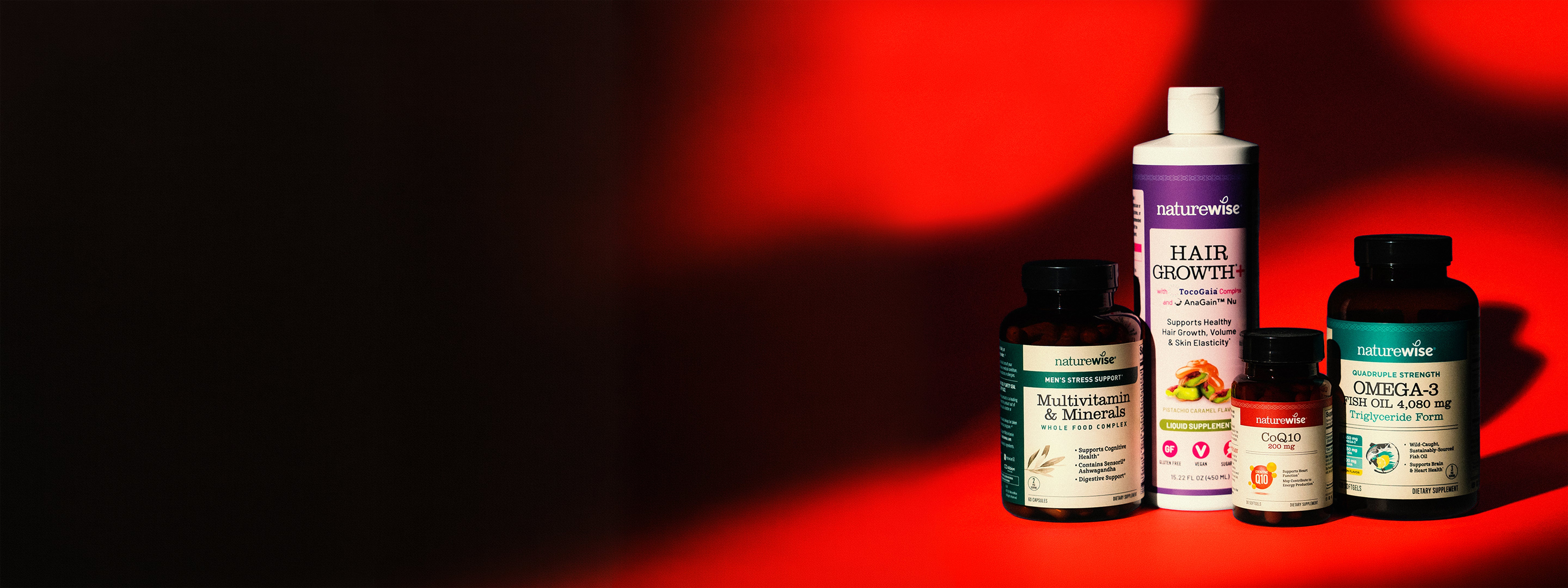 Collection of NatureWise supplement bottles on a red background