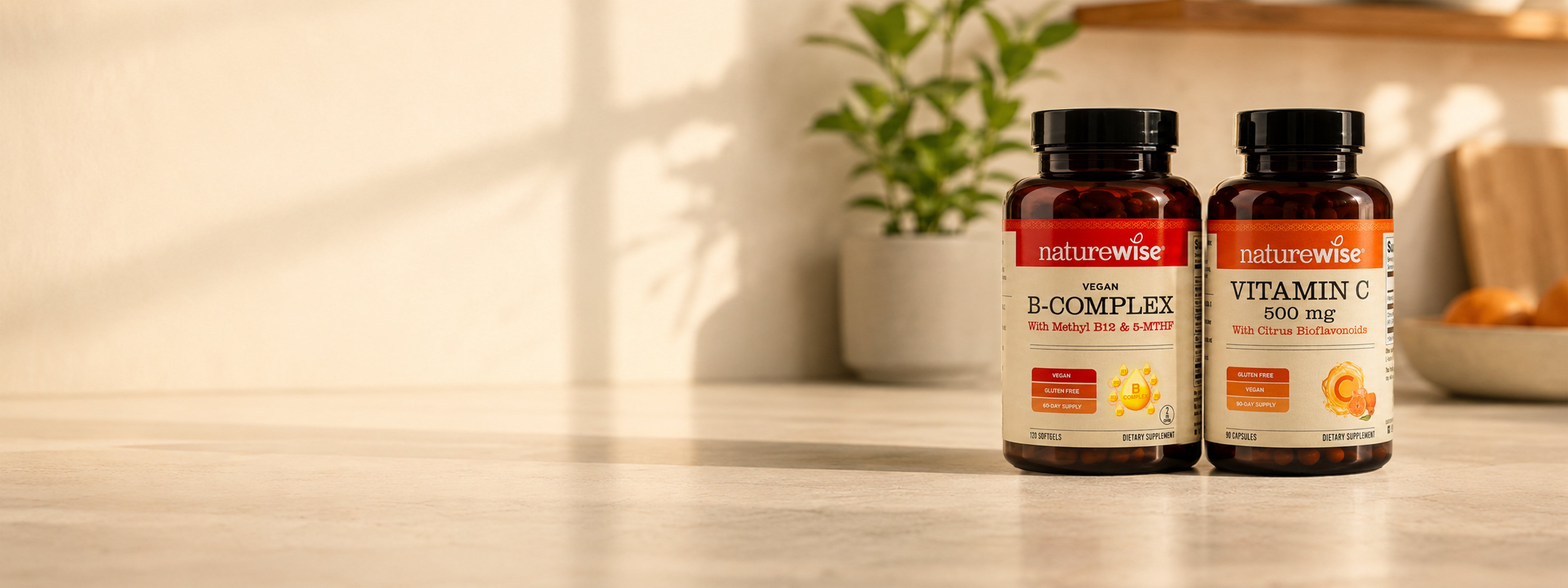 Two amber supplement bottles from naturewise, labeled Vitamin B-Complex 600 mg, standing on a light wooden surface with a warm, sunlit background.