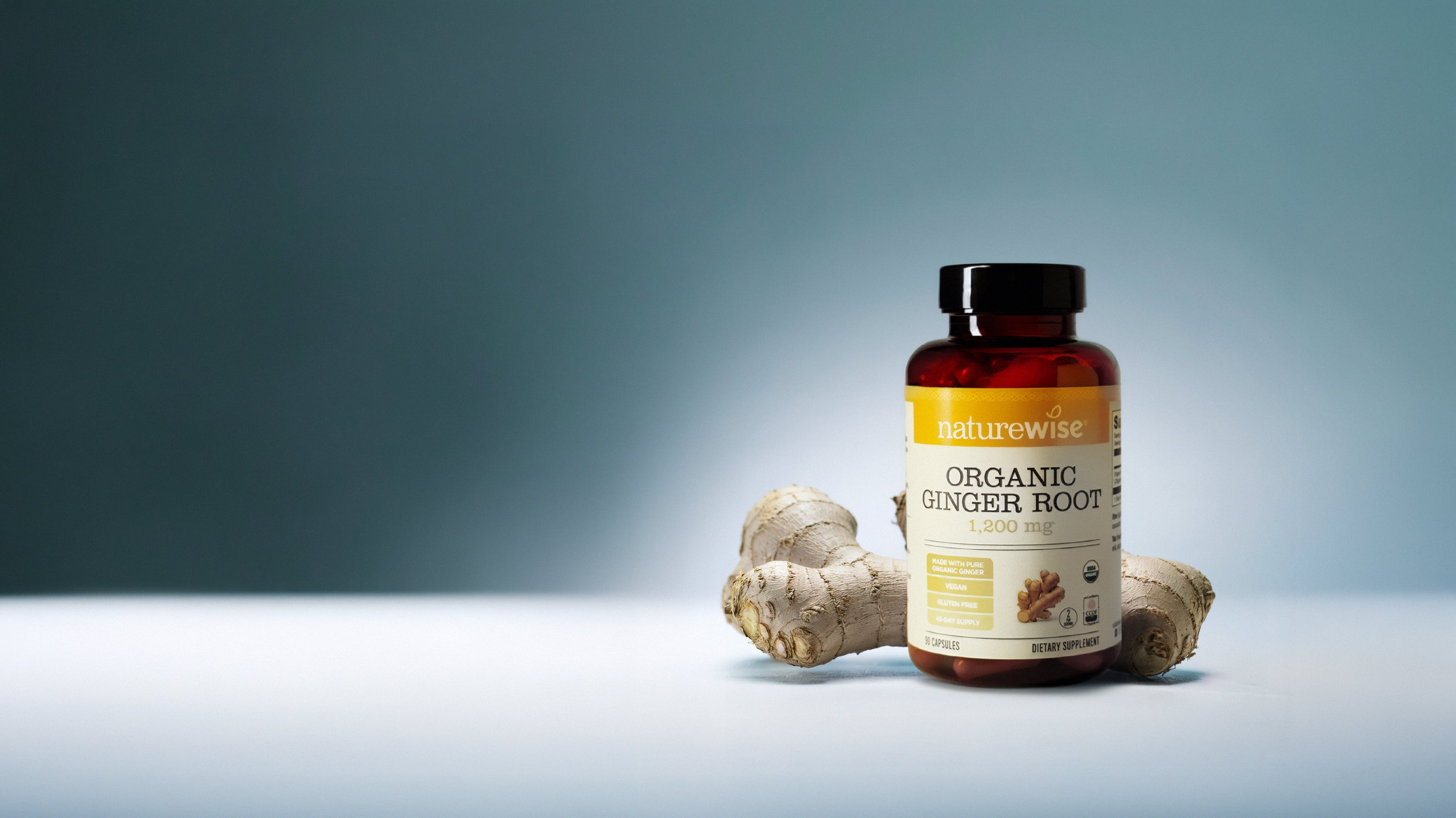 Naturewise Organic Ginger Root supplement bottle with ginger root on a light blue background